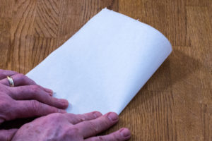 Step 2: Fold the cartouche paper in half again.