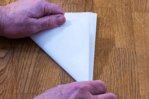 Step 3: Fold your cartouche paper again forming a triangle.