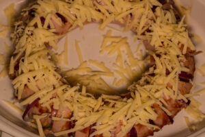We now see the graded cheese on the Falukorv prior to baking.