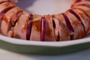 Showing the onion, chili sauce and mustard as placed in the Falukorv.