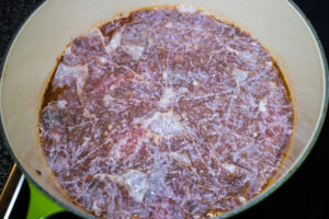 A wetted/oiled cartouche in place for lamb ragout braising.