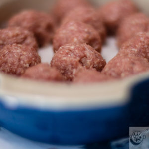 A dish of uncooked meatballs A dish of uncooked meatballs