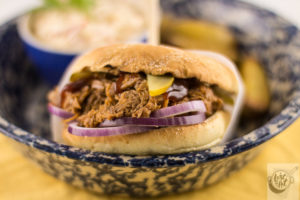 Pulled pork sandwich, all dressed and ready to eat.