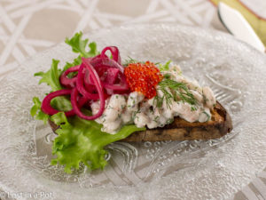 Skagen toast with beet pickled onions and trout roe.