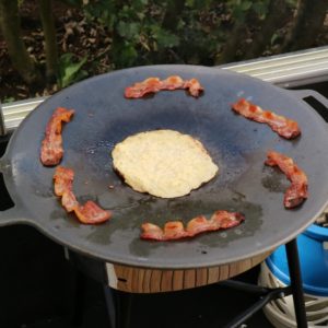Raggmunk and cured pork belly frying on the Muurikka.