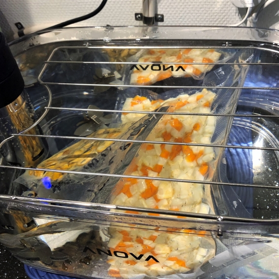 Veggies and mussels reheating in the sous vide.