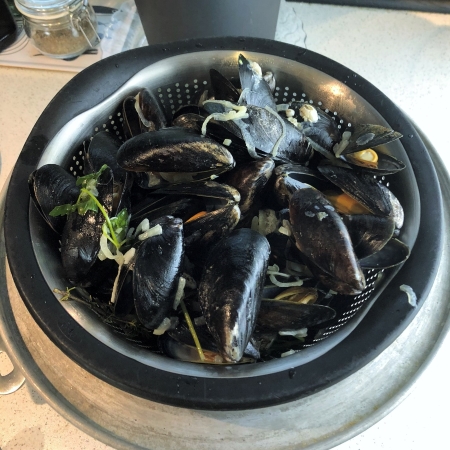 Steamed mussels draining.