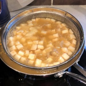 Poaching the veggies in fish stock.