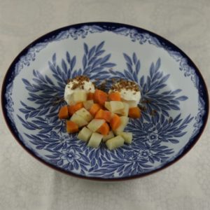Placing the carrots and celeriac in the bowl.