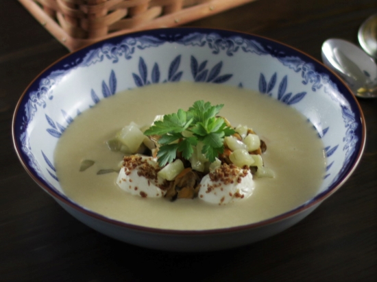 A bowl of mussel soup with smoked fresh cheese and sautéed fennel.