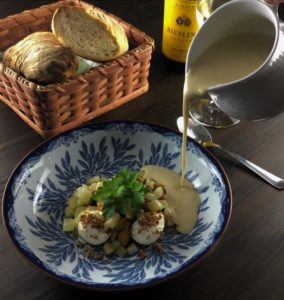 Pouring mussel soup beside the smoked fresh cheese and sautéed fennel.