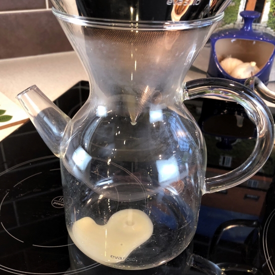 Mussel stock straining through a coffee filter.